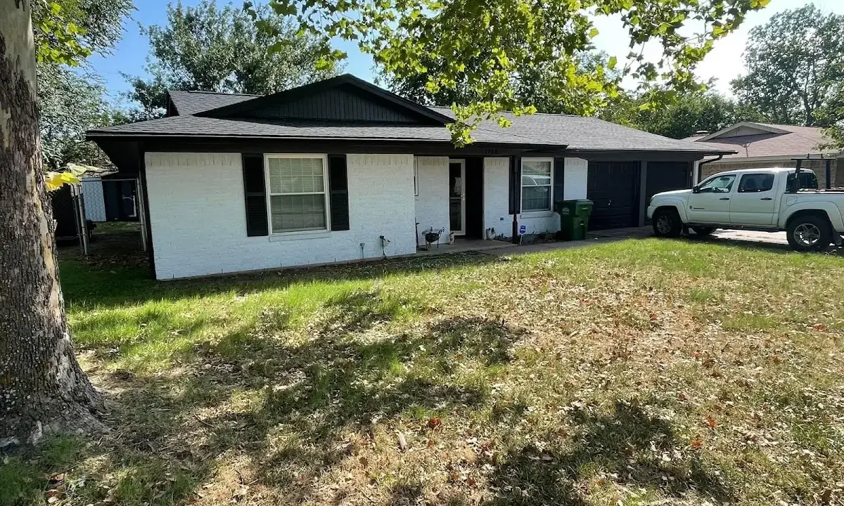 Professional roofing crew working on a residential roof in Swansea